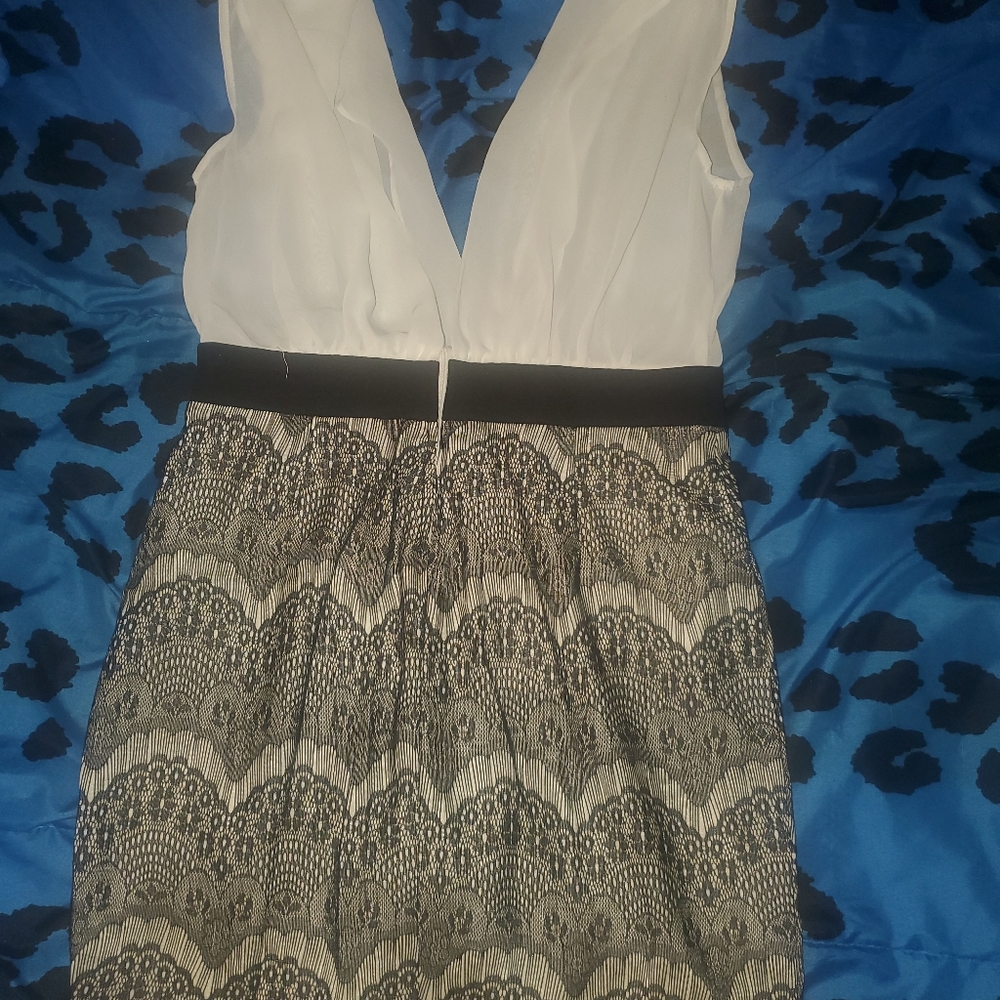 Mini dress. No sleeves. Open chest.